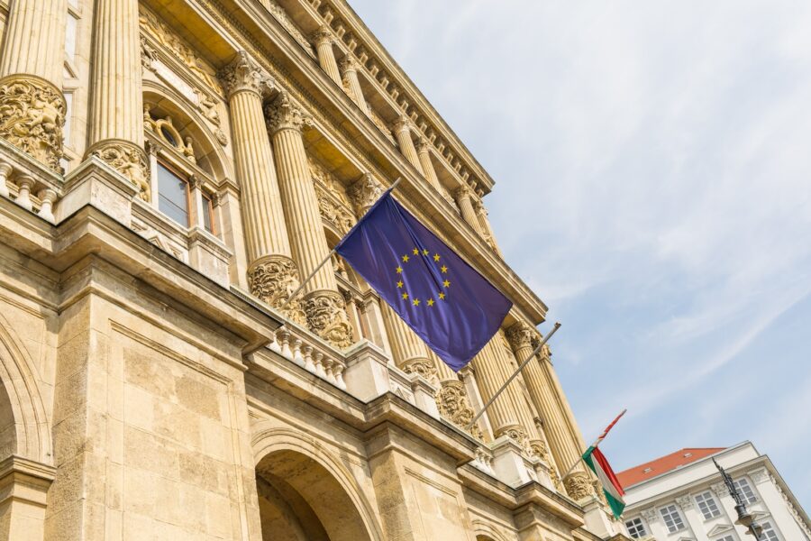a european flag flying in front of a building